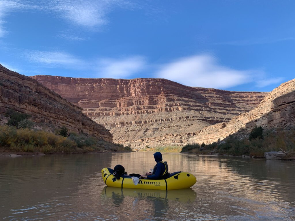 A man packrafting a Kokopelli Rogue R-Deck on the San Juan River, avoiding crowds in the outdoors.