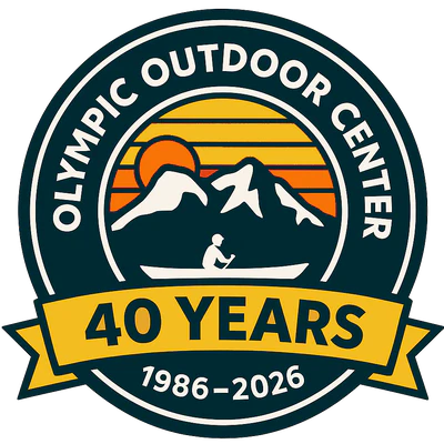 Logo of Olympic Outdoor Center, an outdoor recreation business in Port Gamble, Washington, offering dry suit rentals for kayaking, paddling, and cold-water adventures.